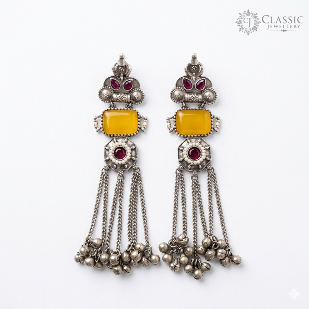 Handcrafted German silver long drop earrings with yellow stones and ruby accents featuring ghungroo tassels by Classicjewellery