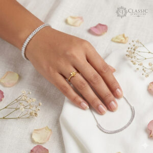 Model wearing a silver baguette-cut diamond tennis bracelet with anti-tarnish finish by Classicjewellery