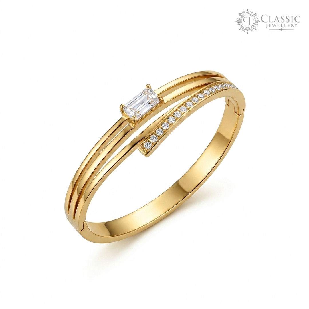 Minimalist gold plated kada featuring a center baguette solitaire and crystal accents by Classicjewellery